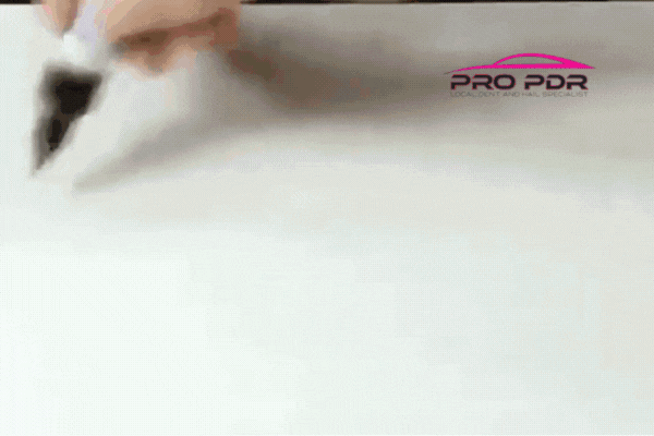 A technician carefully applies a white cloth to a car panel, polishing the surface as part of a ceramic coating service. The Pro PDR logo appears in the top right, emphasizing Professional PDR for Ceramic Coating in Colorado Springs.
