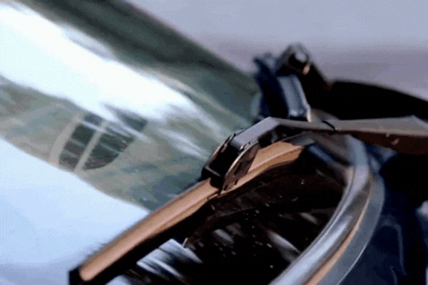 Hail Damage Repair Process begins with a close-up of a technician inspecting a windshield wiper on a hail-hit vehicle in Colorado Springs. Movement in the GIF emphasizes a detailed inspection step, where subtle glass or panel damage is assessed for severity.