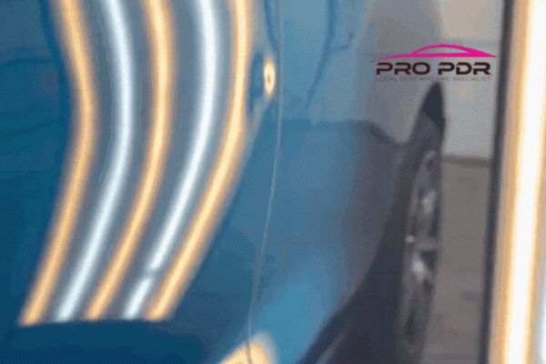 Hail Damage Repair Process completed on a blue vehicle in Colorado Springs, shown through a GIF of a dent being smoothed out under LED reflection lights. The Pro PDR logo emphasizes professional paintless dent repair services with flawless results.