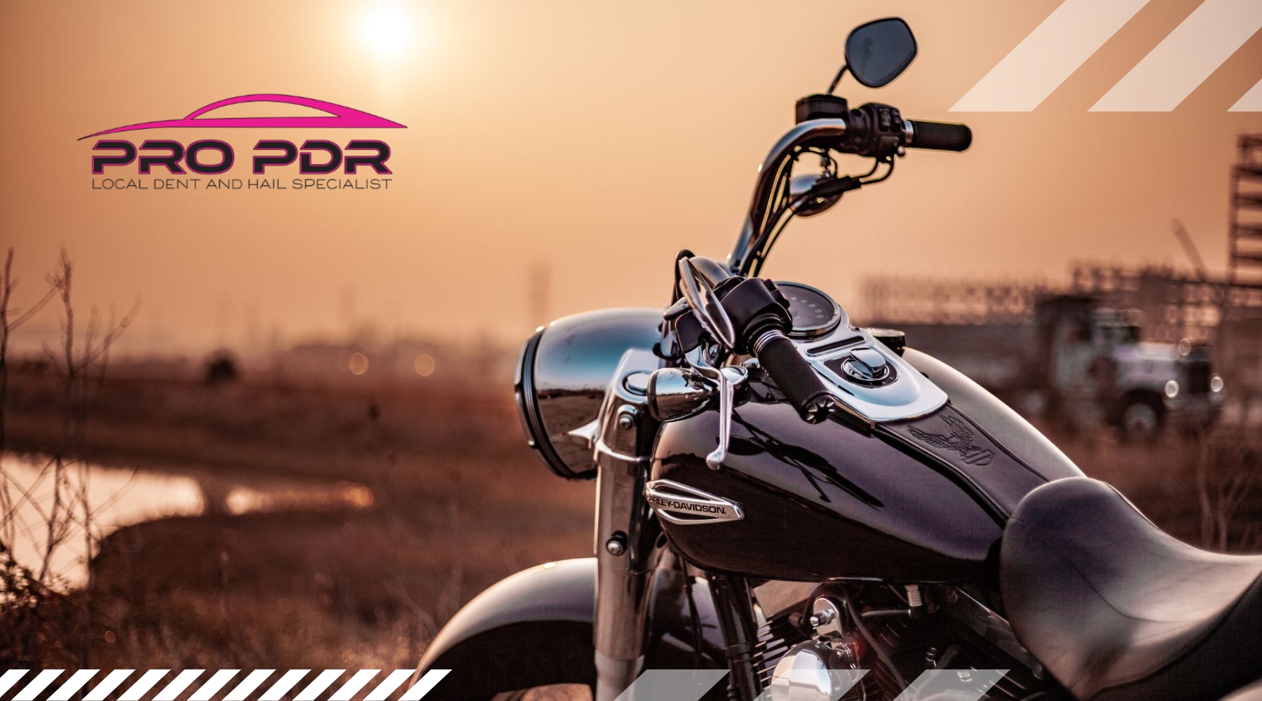 Close-up of a Harley-Davidson motorcycle parked outdoors at sunset near a construction site, with the Pro PDR logo in the sky, representing a local Colorado Springs dent repair specialist and emphasizing how paintless dent repair works for motorcycles.