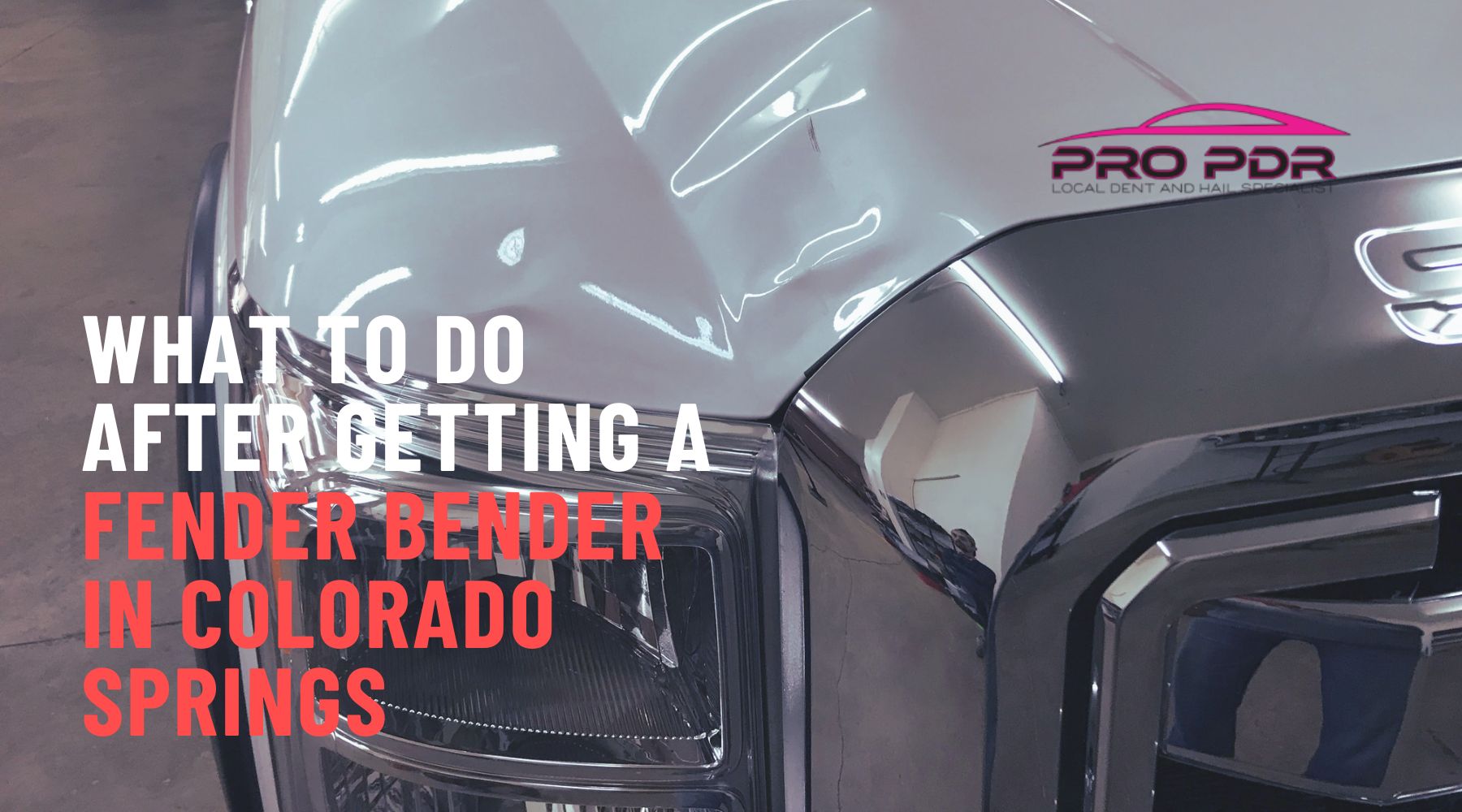 Close-up of a silver truck with a noticeable dent above the headlight, alongside bold text reading &ldquo;What to do after getting a fender bender in Colorado Springs&rdquo; and the Pro PDR logo in the corner.