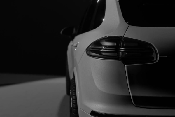 White SUV shown from the rear side in a clean studio setting