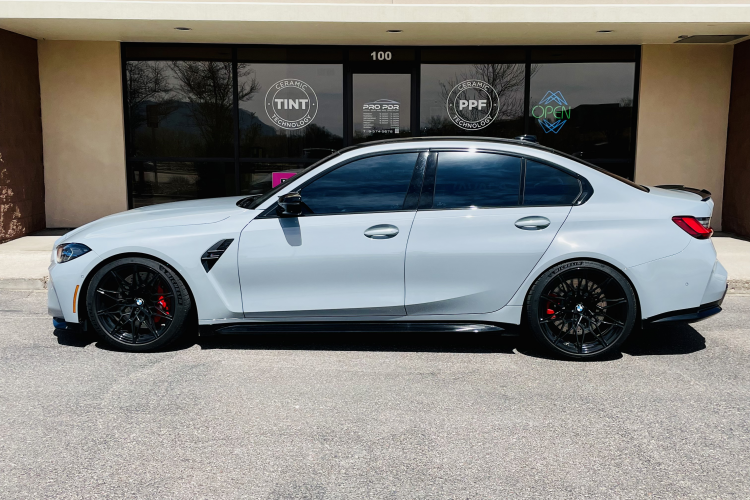 Gray luxury sedan parked outside Pro PDR storefront, showcasing window tinting and paint protection film services.